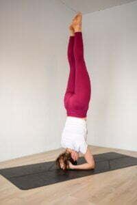 woman doing headstand yoga